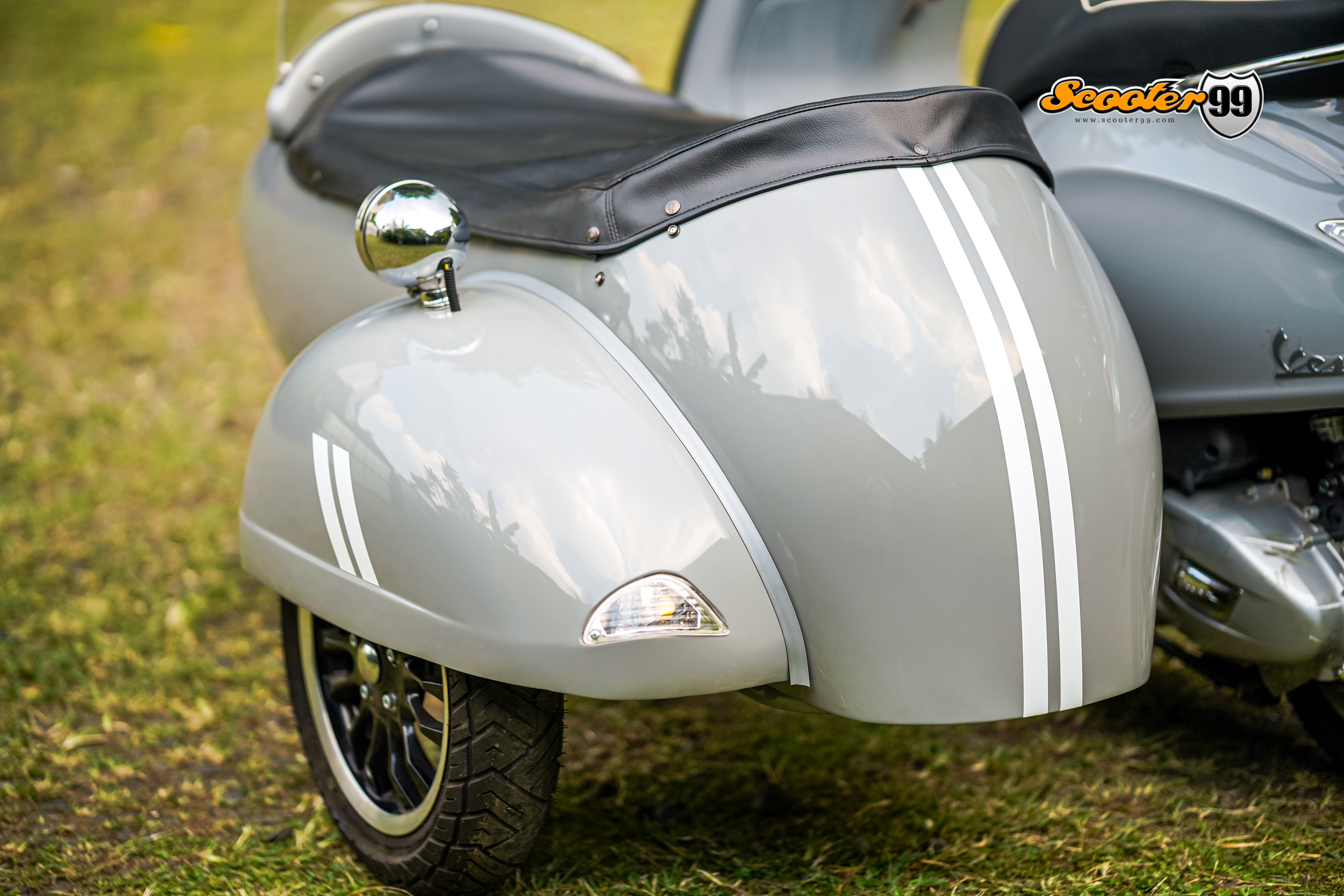 Close-up of Vespa Sprint sidecar wheel and fender